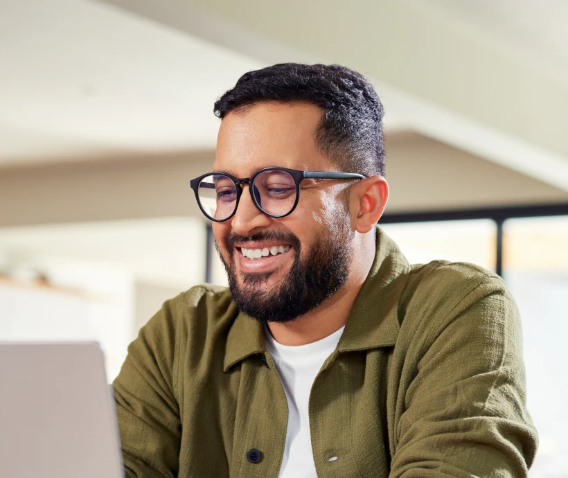 denturetech man smiling laptop